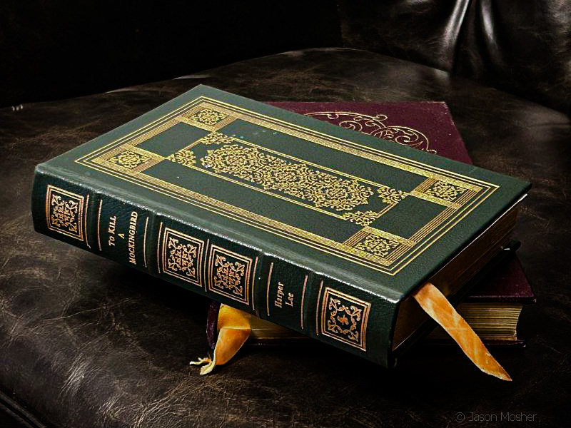 A green leather classic book on a leather chair.